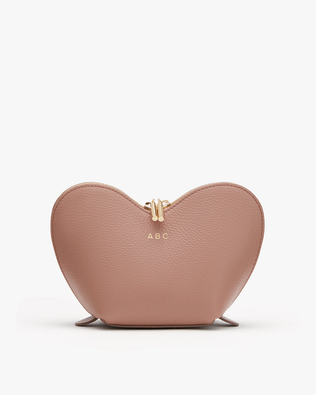 Heart-shaped purse with clasp closure and initials ABC on front.