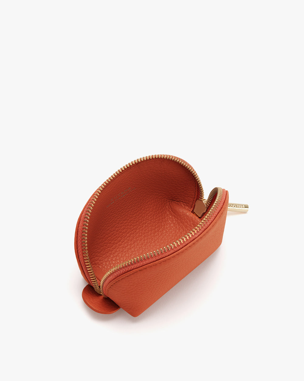 Small open coin purse with zipper on a white background