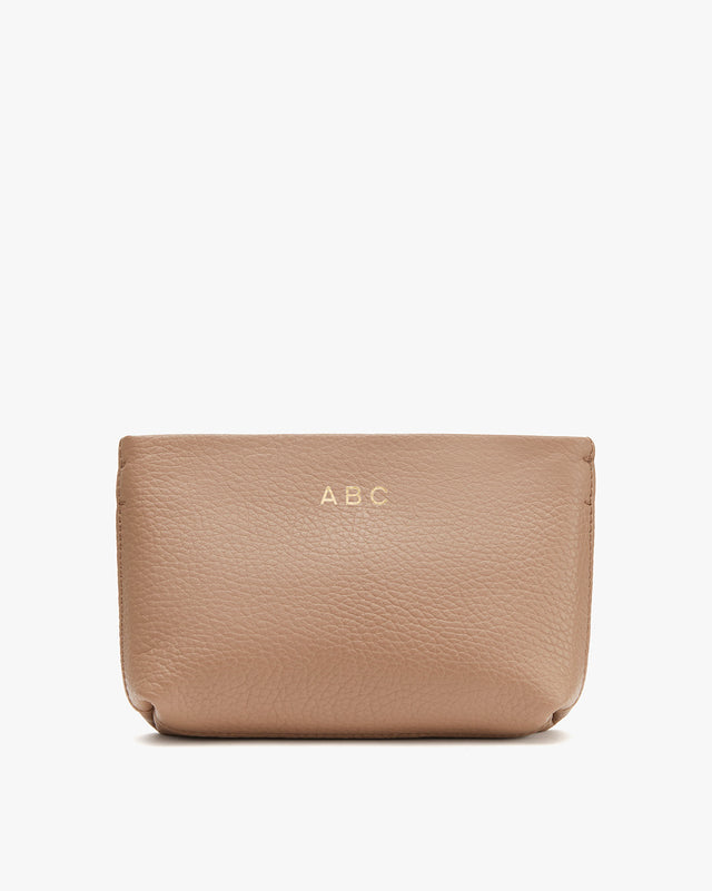 Leather pouch with the initials A.B.C embossed on it.