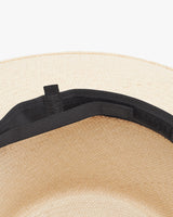 Close-up view of a hat with a strap attached inside.