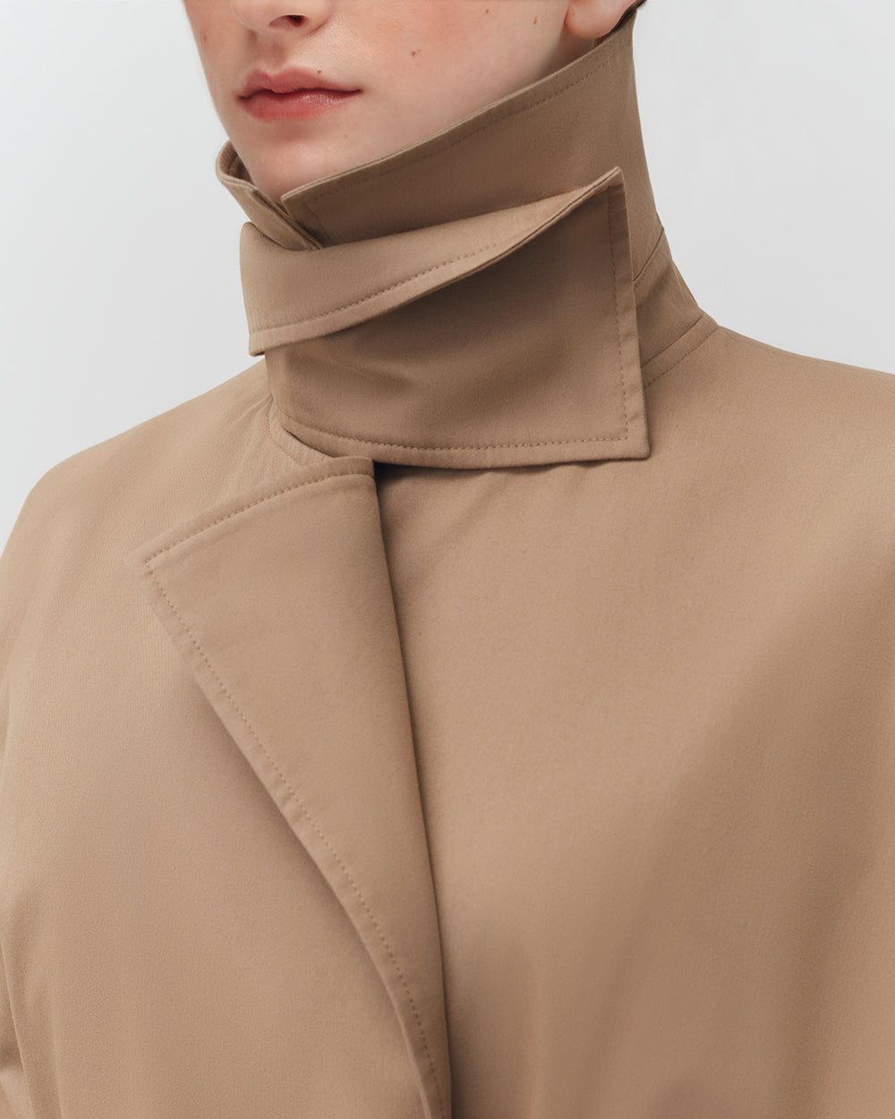 Close-up of a person wearing a high-neck jacket.