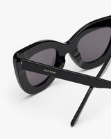 Cat-eye sunglasses with thick frame and brand logo on the arm.