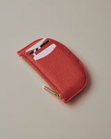 Small curved wallet on a plain background.