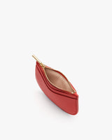 Small curved wallet with open zipper viewed from above.