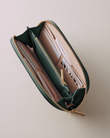 Open wallet with multiple card slots and zippers on a flat surface.