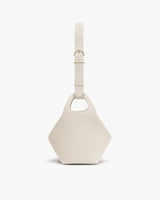 Hexagonal bag with a wide strap and cutout handle.