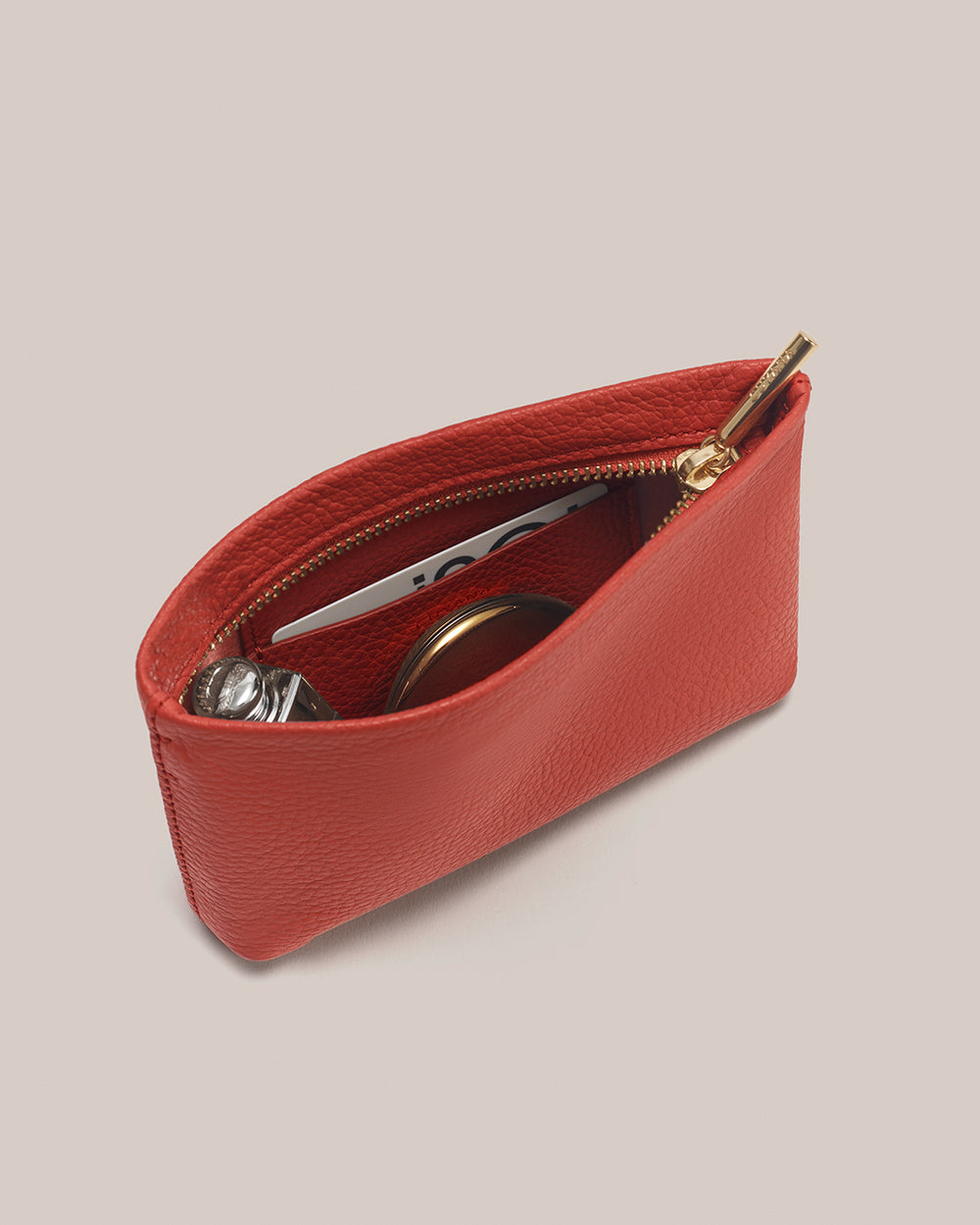Small pouch with zipper partially open, showing items inside.