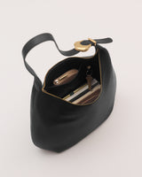 Open handbag showing contents including a wallet, keys, and sunglasses.