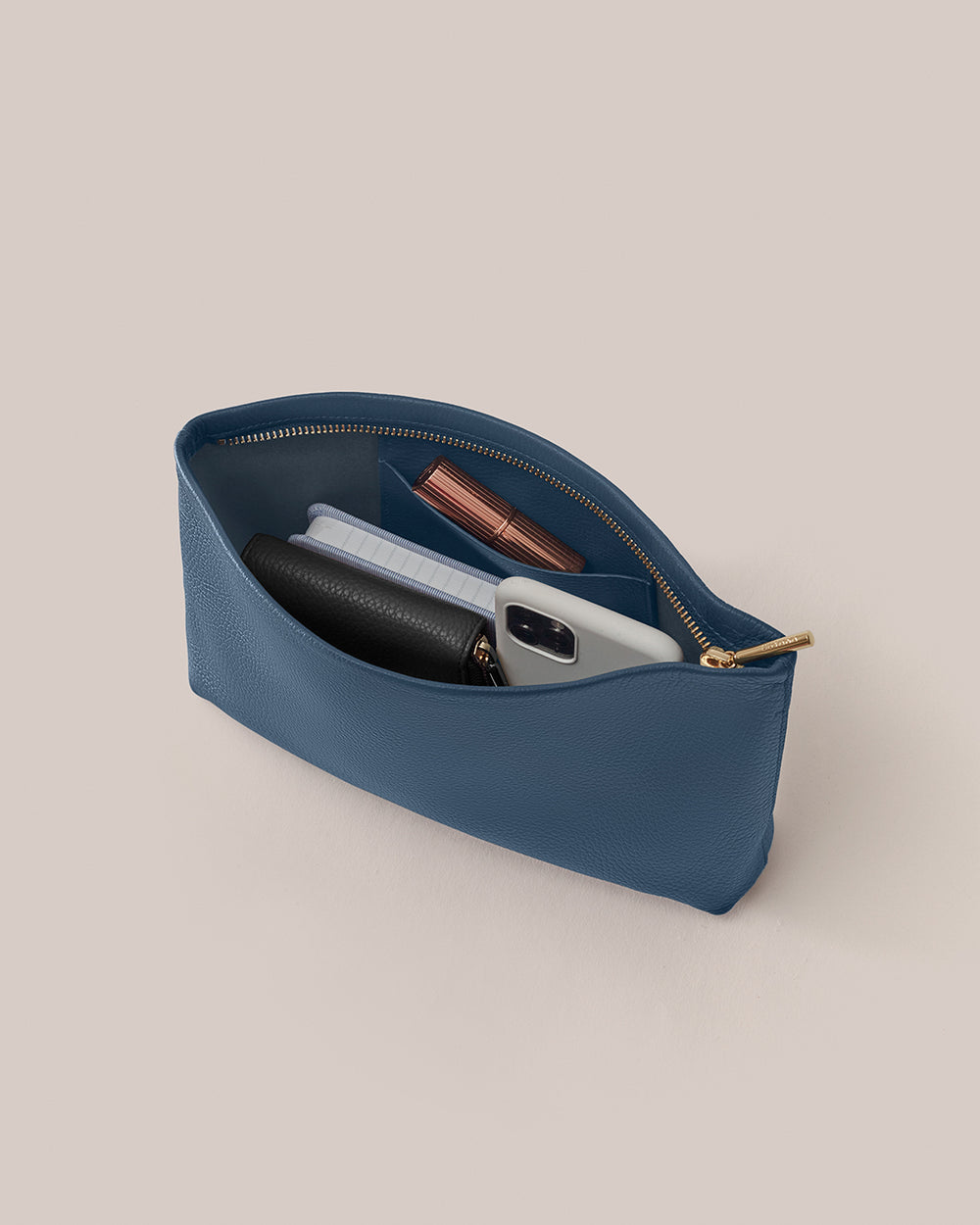 Open pouch with phone, wallet, and makeup items inside