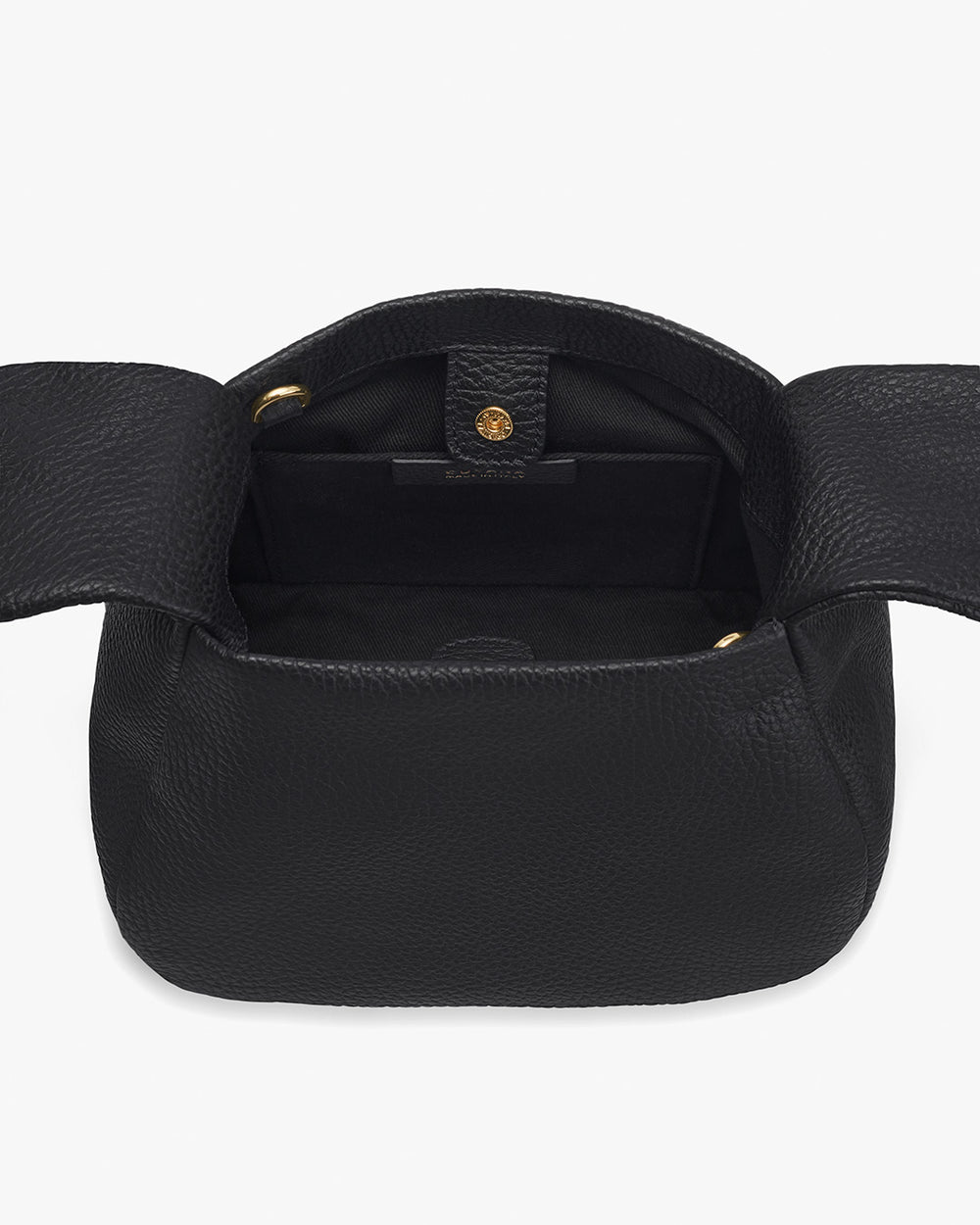 Open handbag with flap, button closure, and empty interior, showing shoulder strap rings.