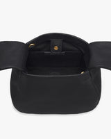 Open handbag with flap, button closure, and empty interior, showing shoulder strap rings.