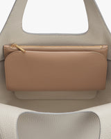 Wallet resting inside an open handbag