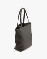 Tote bag standing upright on a solid surface.