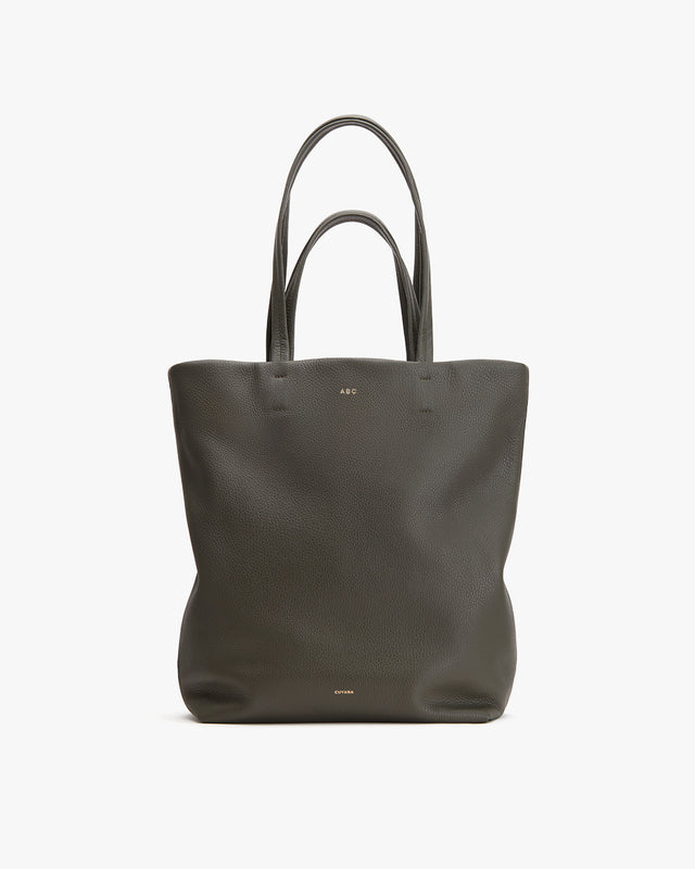 Tote bag with two handles and a logo at the top center.