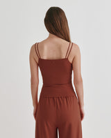 Woman standing with her back facing the camera.