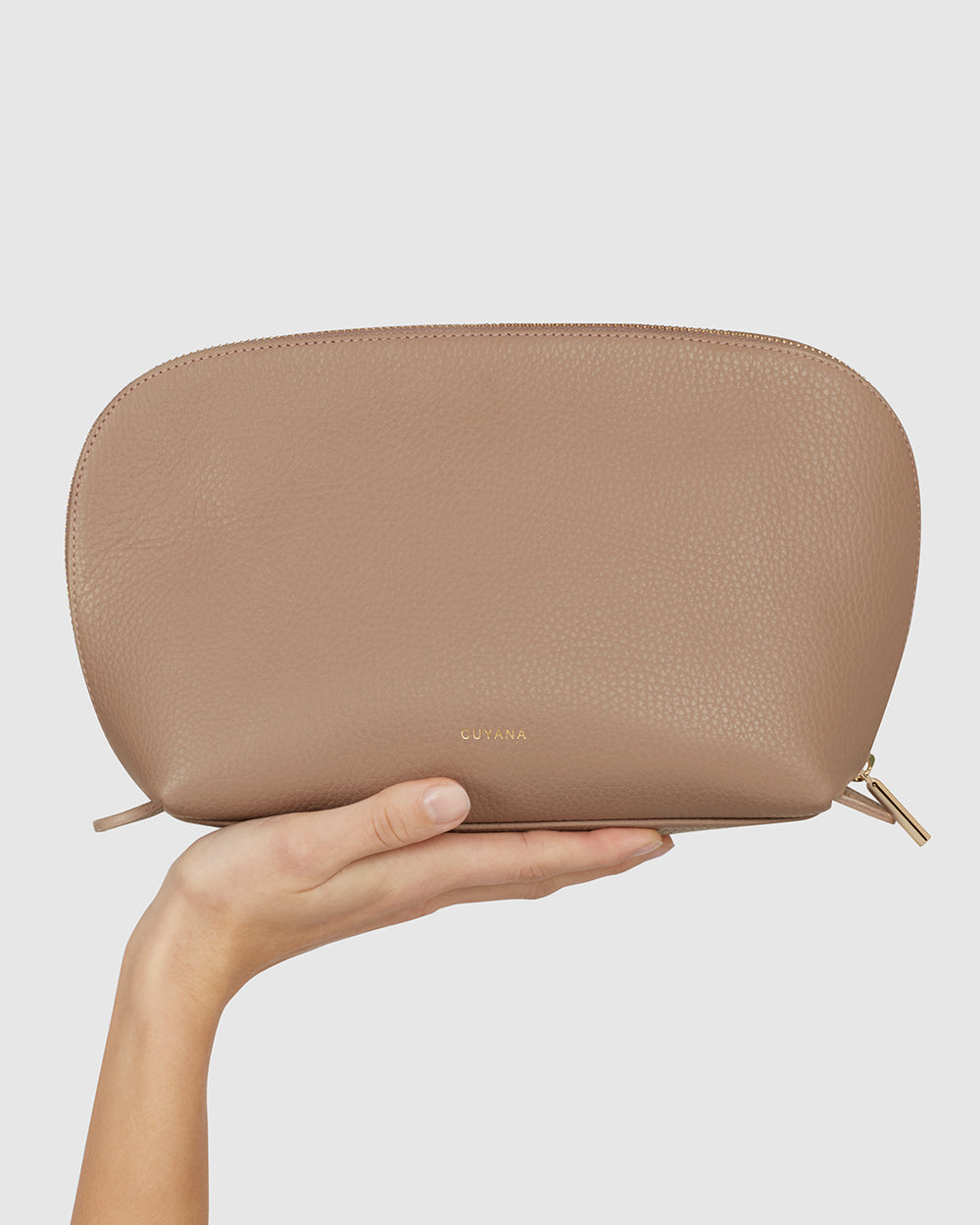 Hand holding a small zipper pouch