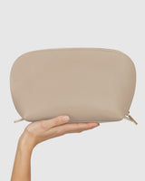 Hand holding a small zipped pouch.