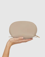 Hand holding a small zippered pouch.