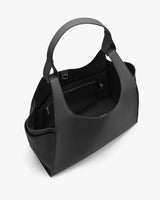 Open handbag with internal compartments and a top handle.