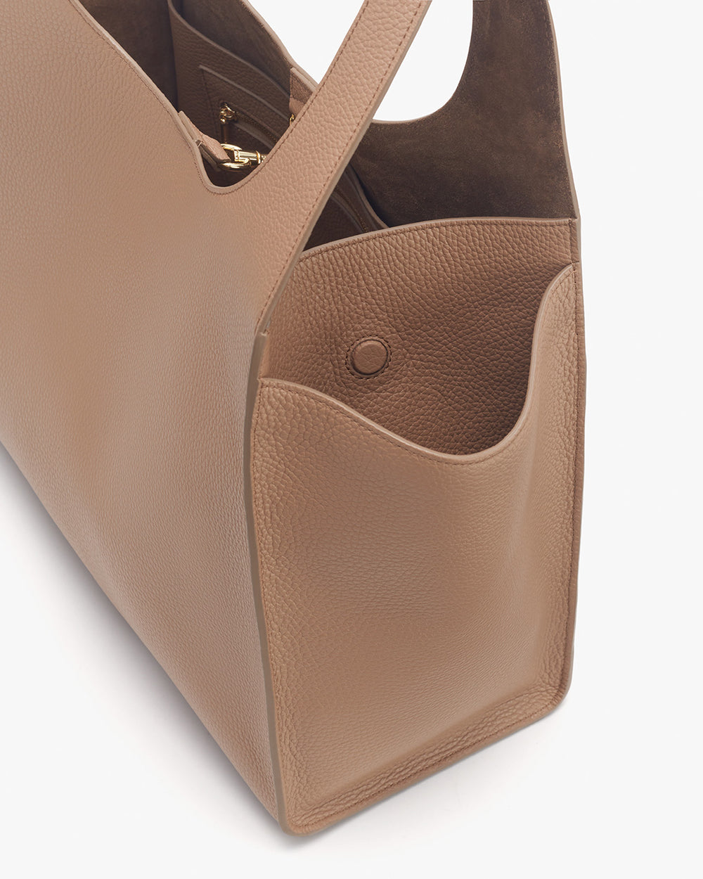 Close-up view of a handbag with open top and side pocket.