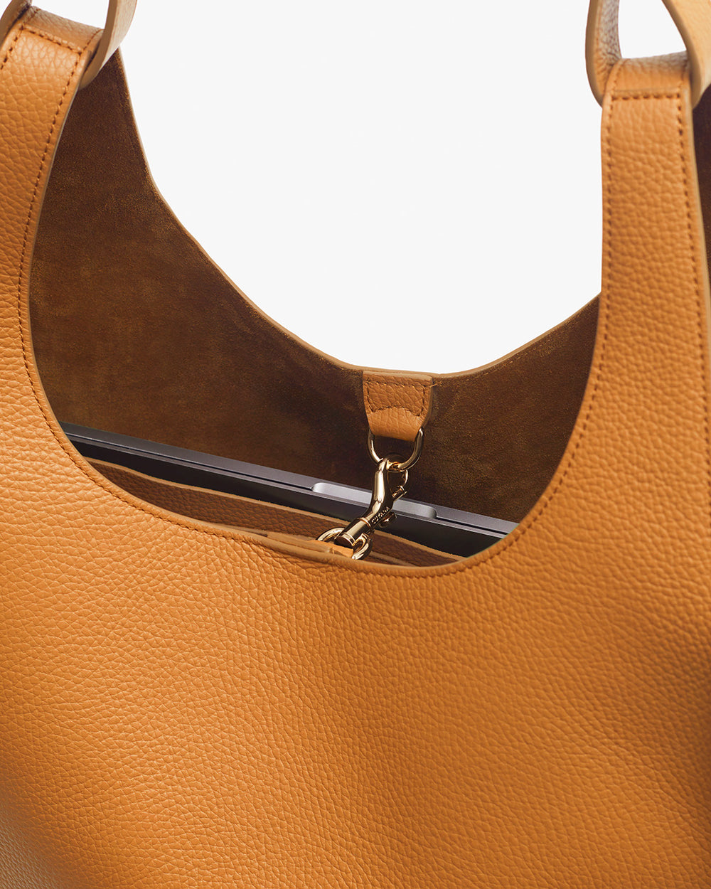Close-up of a handbag with a metallic clasp and visible interior lining.