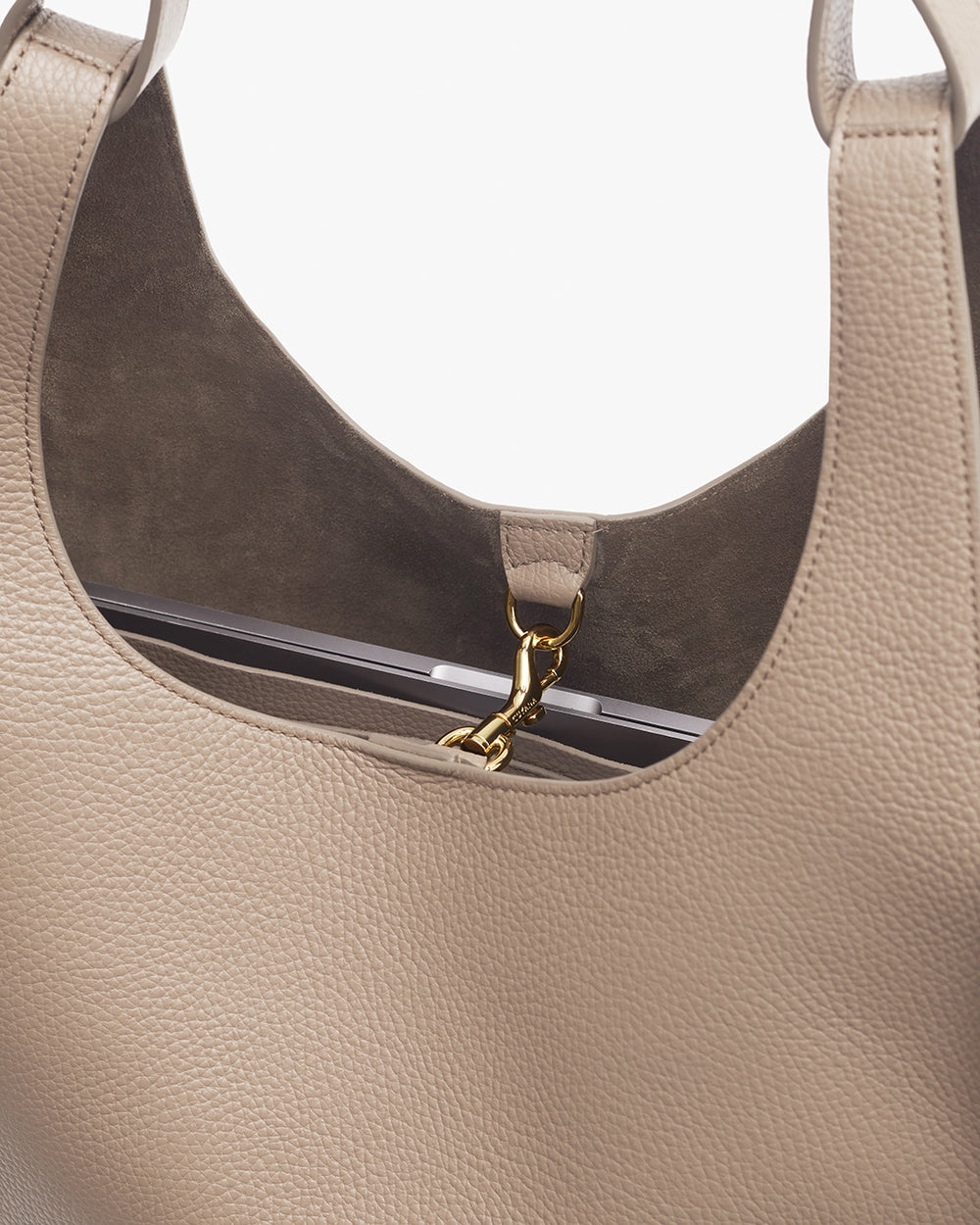 Close-up view of an open handbag with visible interior and clasp detail.