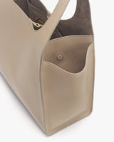 Close-up of a handbag with an inner compartment and outer pocket.