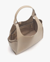 Open handbag with handles and zipper compartments visible.