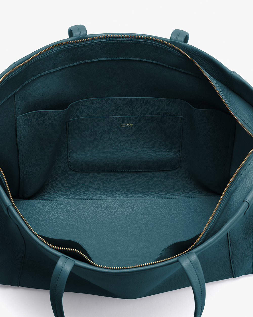 Open travel bag with a zippered opening and an interior pocket
