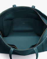 Open travel bag with a zippered opening and an interior pocket