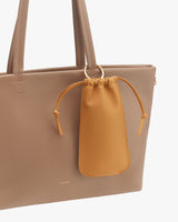 Tote bag with a small drawstring pouch attached to the handle