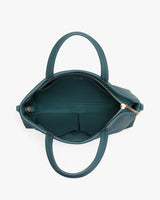 Open structured handbag with handles and visible interior pockets, seen from above.