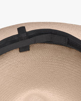 Close-up of a hat with a ribbon detail.