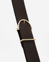 Close-up of a leather with a gold buckle.