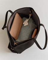 Open tote bag with pouch and a gray scarf inside.