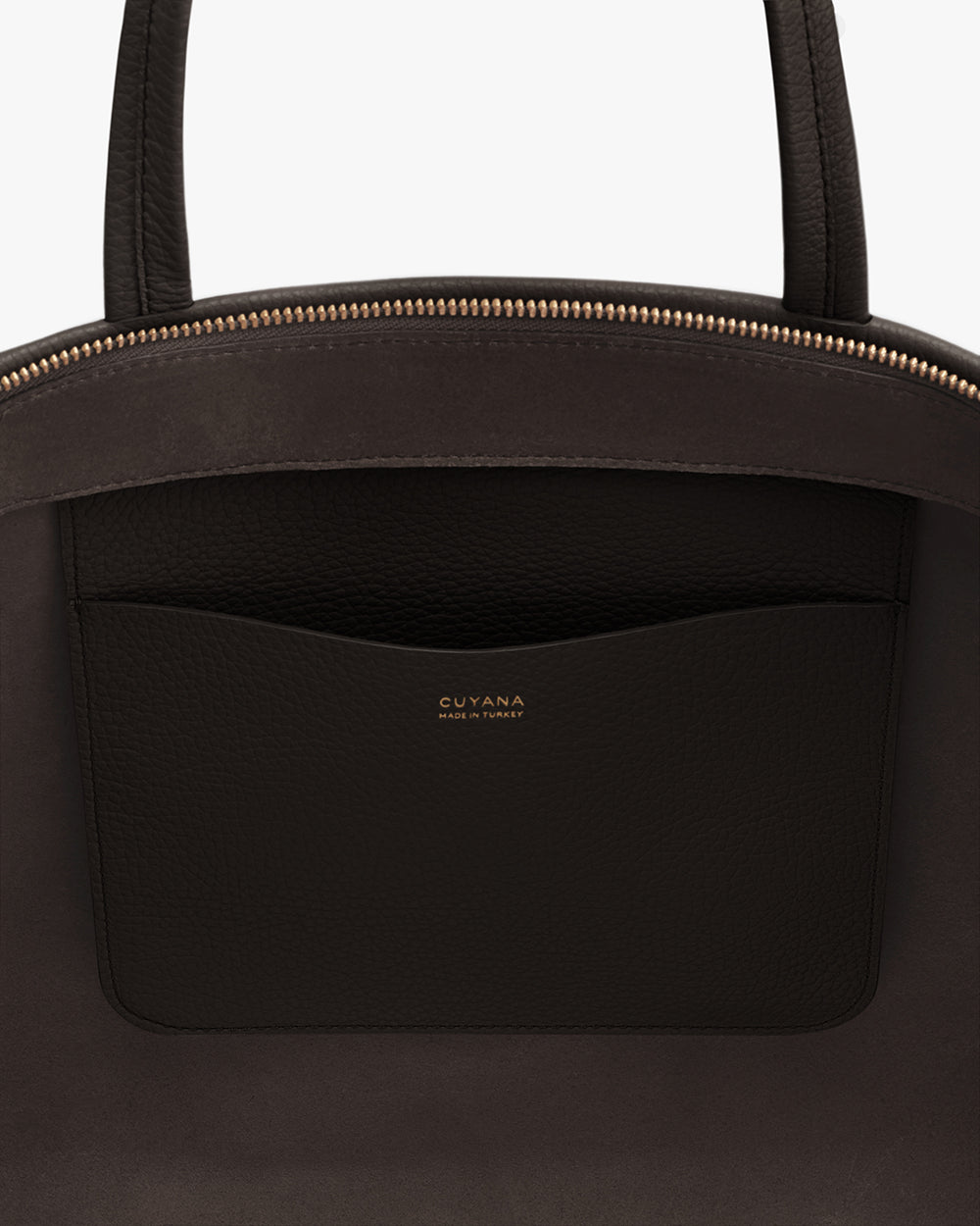 Close-up of a bag with a pocket featuring gold text detailing.