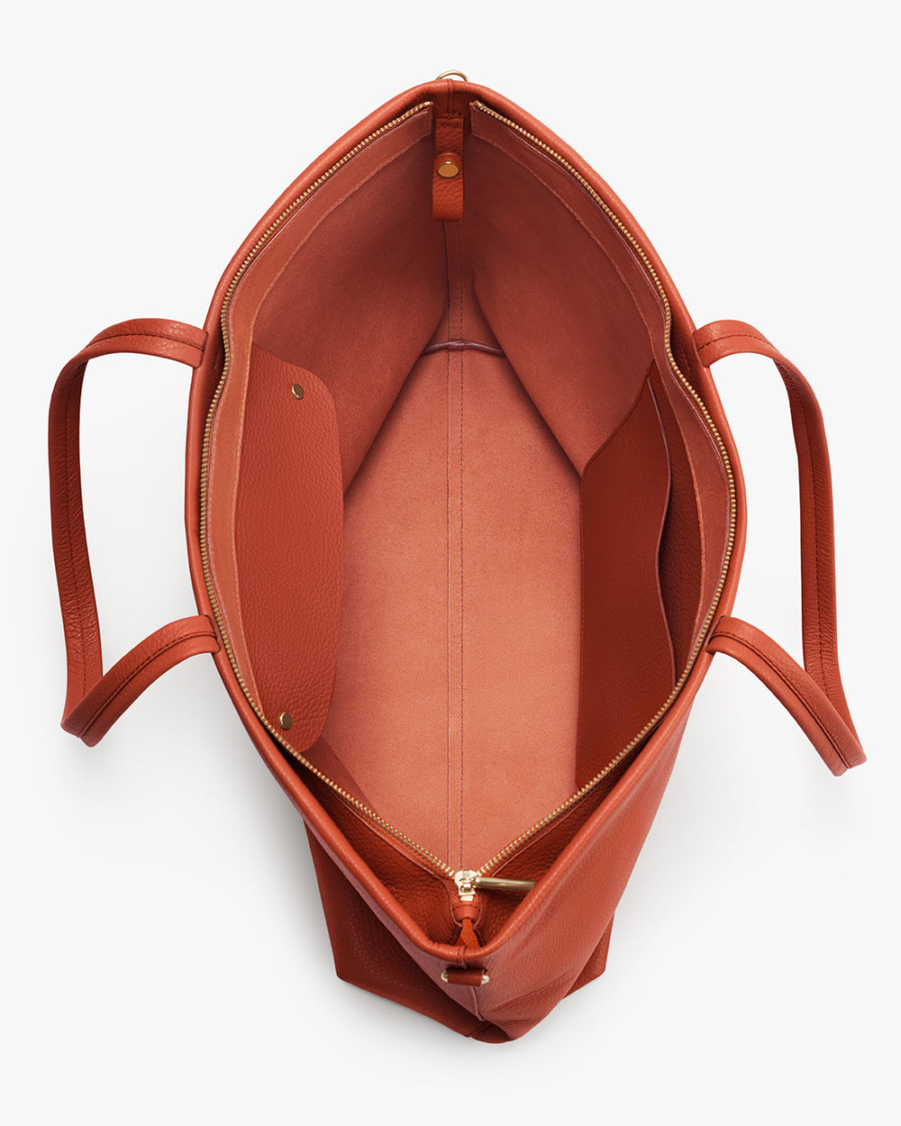Open top view of a large handbag with two straps and an interior pocket