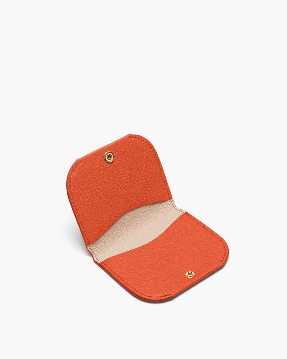 Small open coin purse with button closure lying flat