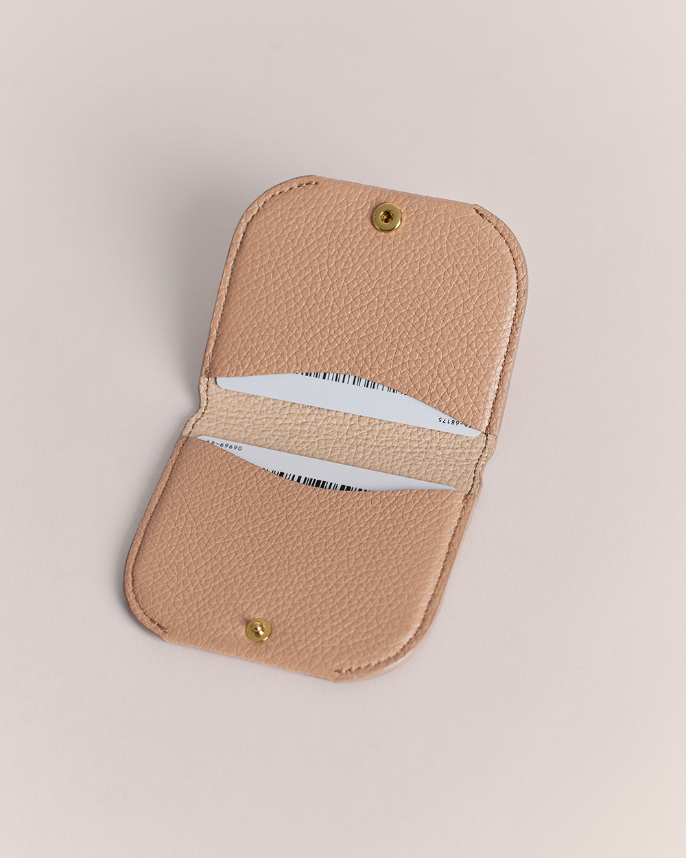 Open wallet with two visible card slots on a plain background.