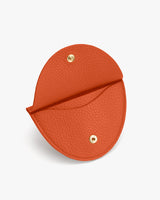 Small half-moon pouch with a snap closure.