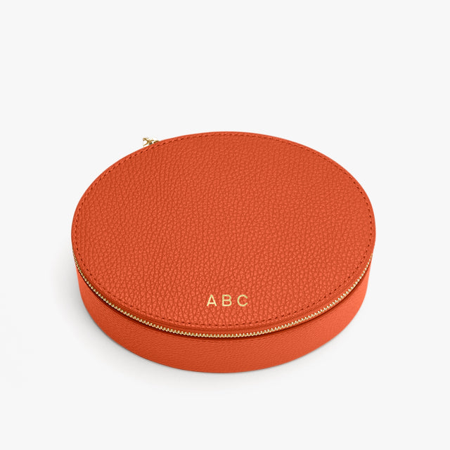 Oval leather case with monogrammed initials ABC on top.