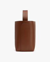 Tall bag with a handle on top viewed from the side.
