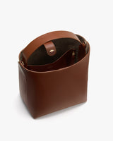 Open-top bag with visible interior pocket and button closure