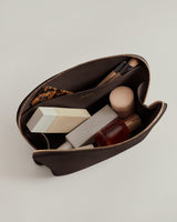 Open pouch with cosmetics and brushes inside