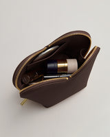 Open makeup bag with skincare products inside