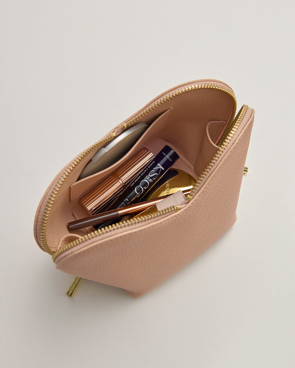 Small open pouch with makeup items inside