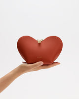 Heart-shaped pouch held in a person's hand