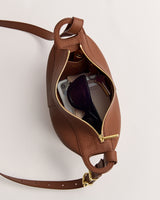 Open bag with sunglasses, phone, and keys visible inside.