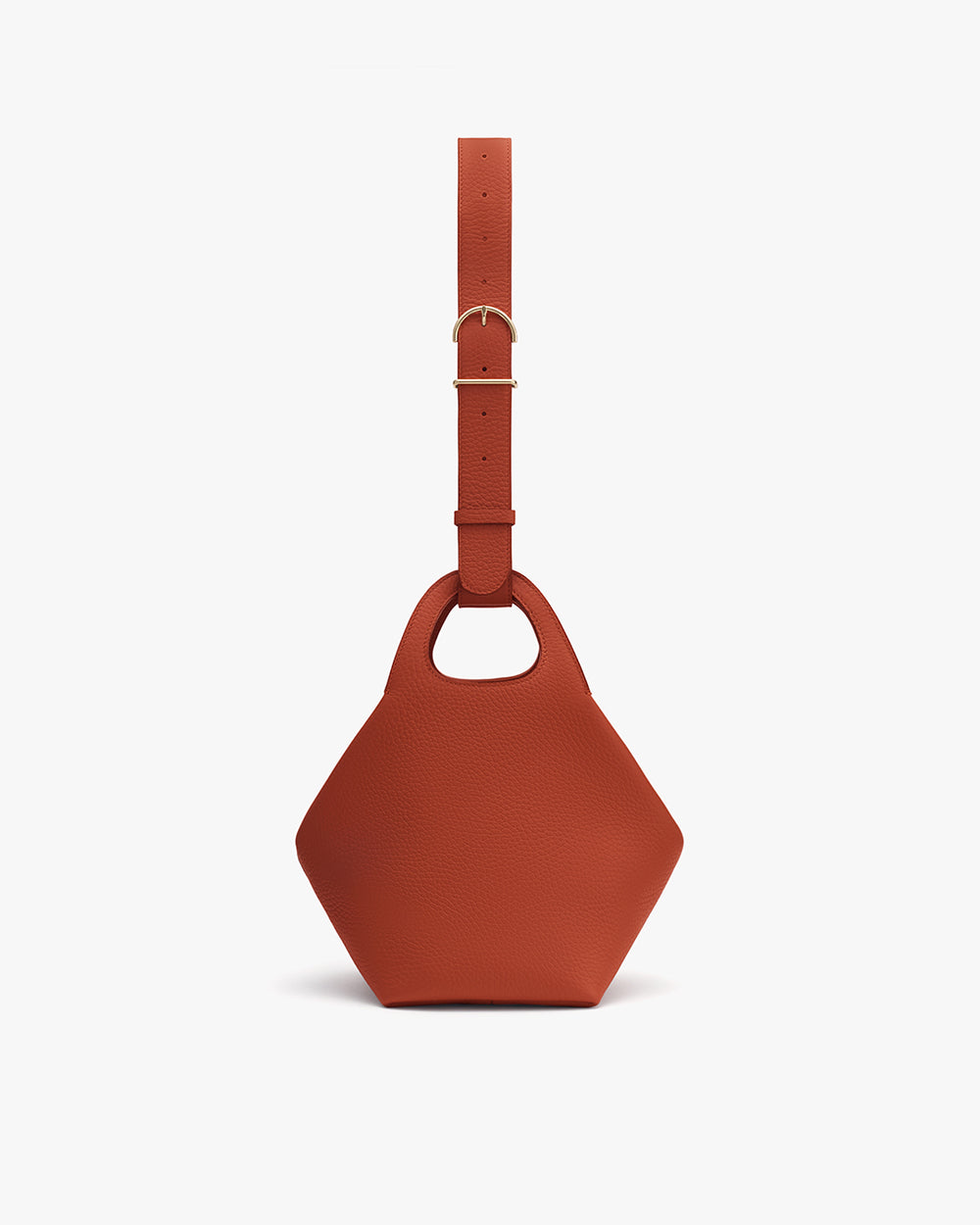 Hexagonal handbag with wide strap and round cut-out handle.