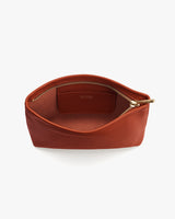 Open leather pouch with visible zipper and inner label.